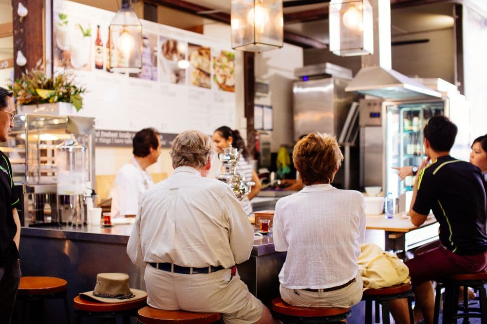 Salão de um restaurante com clientes sentados ao balcão